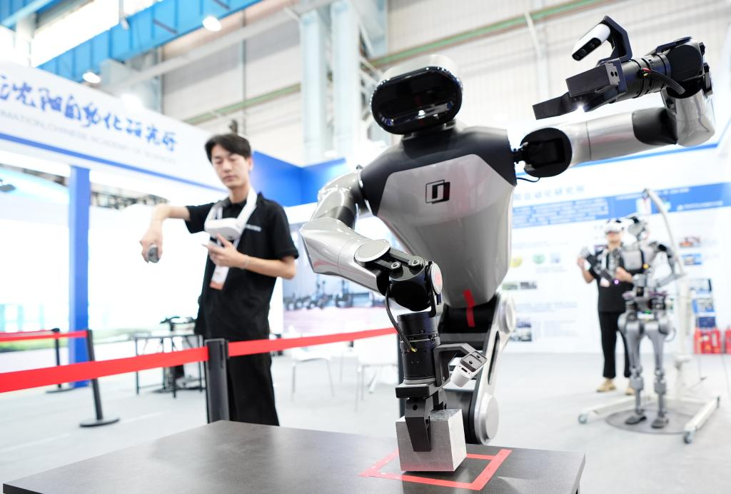 機(jī)器人工程師在調(diào)試具身智能操作系統(tǒng) 來(lái)源：新華社