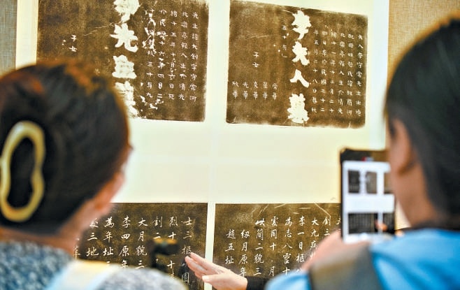 觀眾認真觀看李大釗烈士和夫人墓碑拓片。