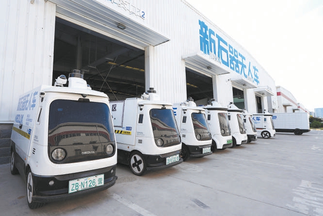 在新石器無人車智慧物流工廠，一排無人車整裝待發(fā)。